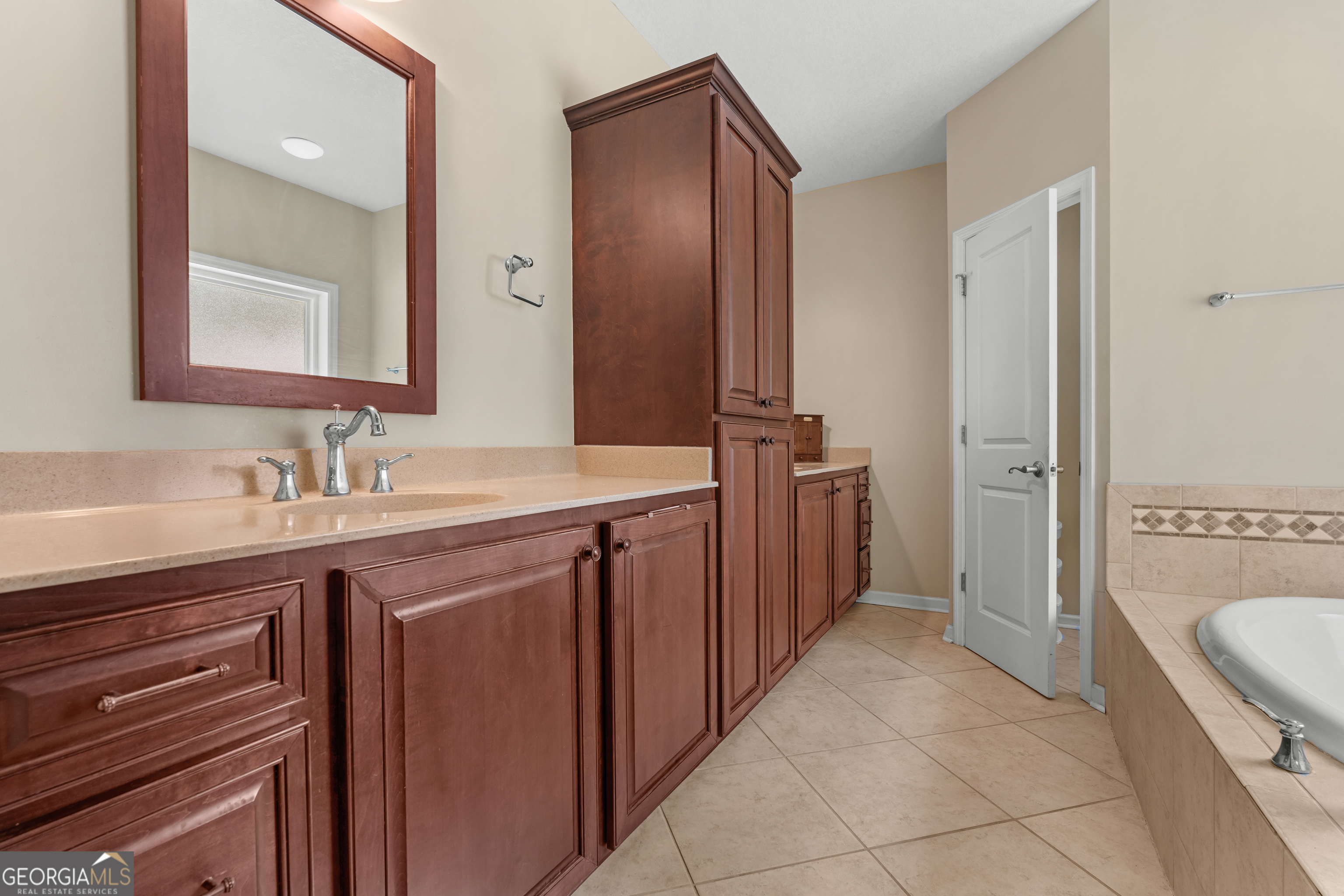480 Best Bridge Road Sylvania, GA 30467 - Photo 26 of 57 a spacious bathroom with a granite countertop sink a mirror and a bathtub