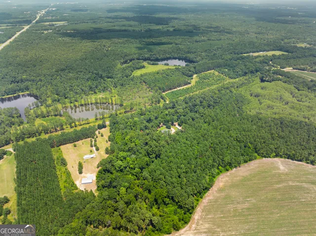 an aerial view of a house with a yard