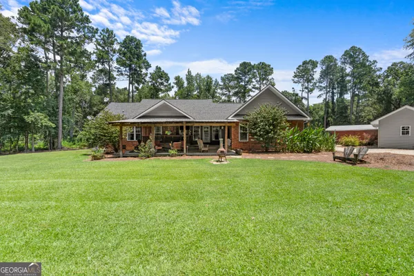 a living room with furniture a fireplace and a chandelier