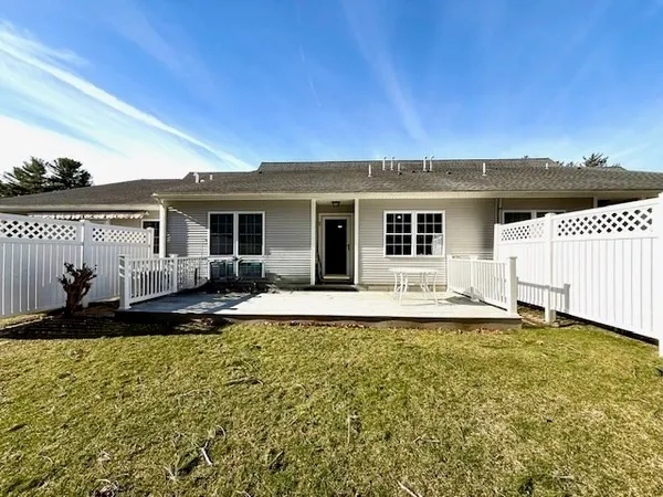 a view of a house with backyard and porch
