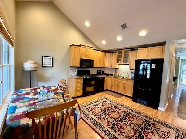 a kitchen with kitchen island granite countertop lots of counter top space and stainless steel appliances