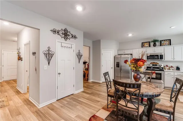 a view of a dining room with furniture and a kitchen