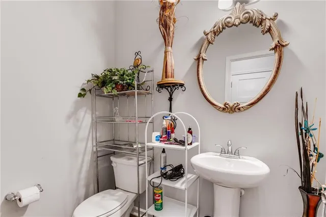a bathroom with a sink mirror and toilet
