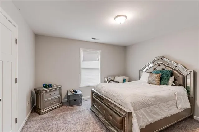 a bedroom with a bed and a view of bedroom