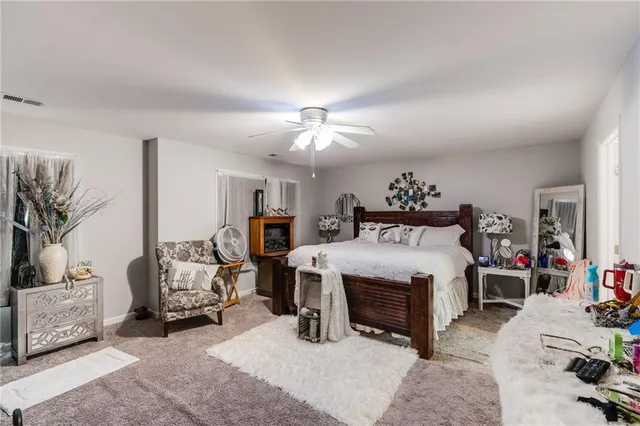 a bedroom with bed and a chandelier