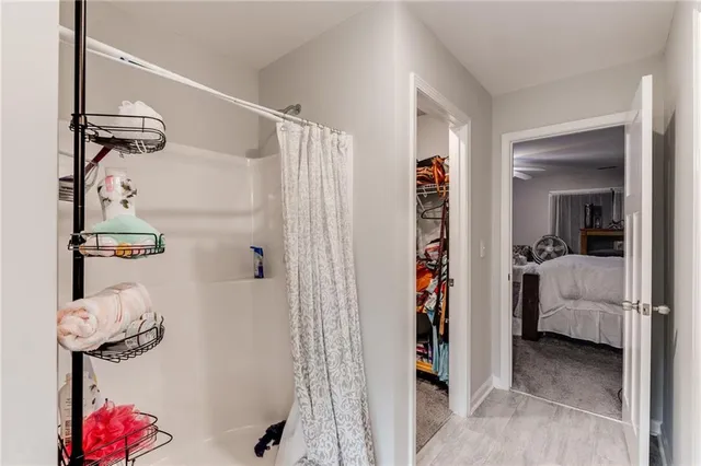 a view of walk in closet with clothes and shoes
