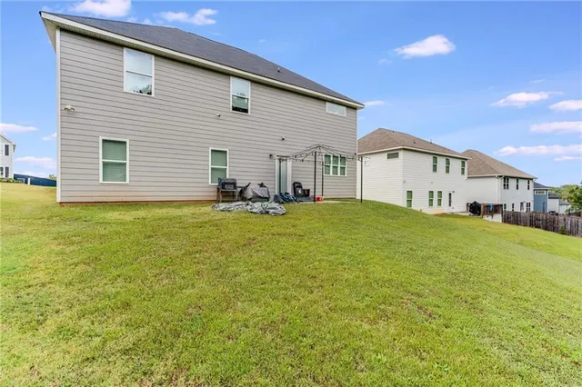 a view of a house with a yard and sitting area