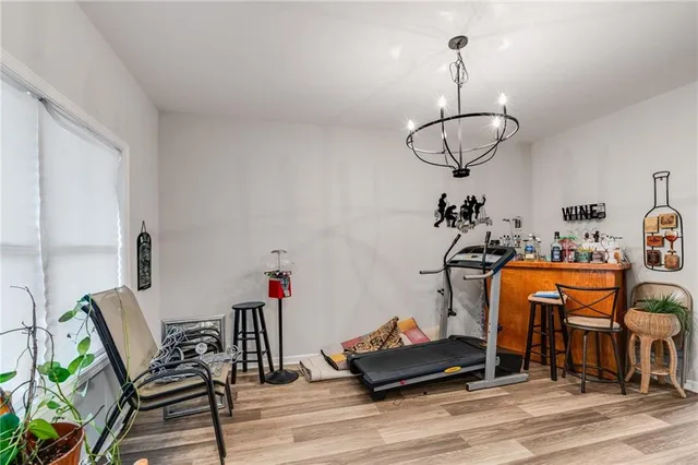 a view of dining room and livingroom with furniture wooden floor windows