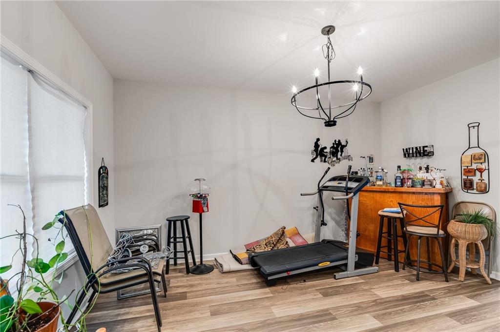 227 Waters Edge Parkway Temple, GA 30179 - Photo 5 of 26 a view of dining room and livingroom with furniture wooden floor windows