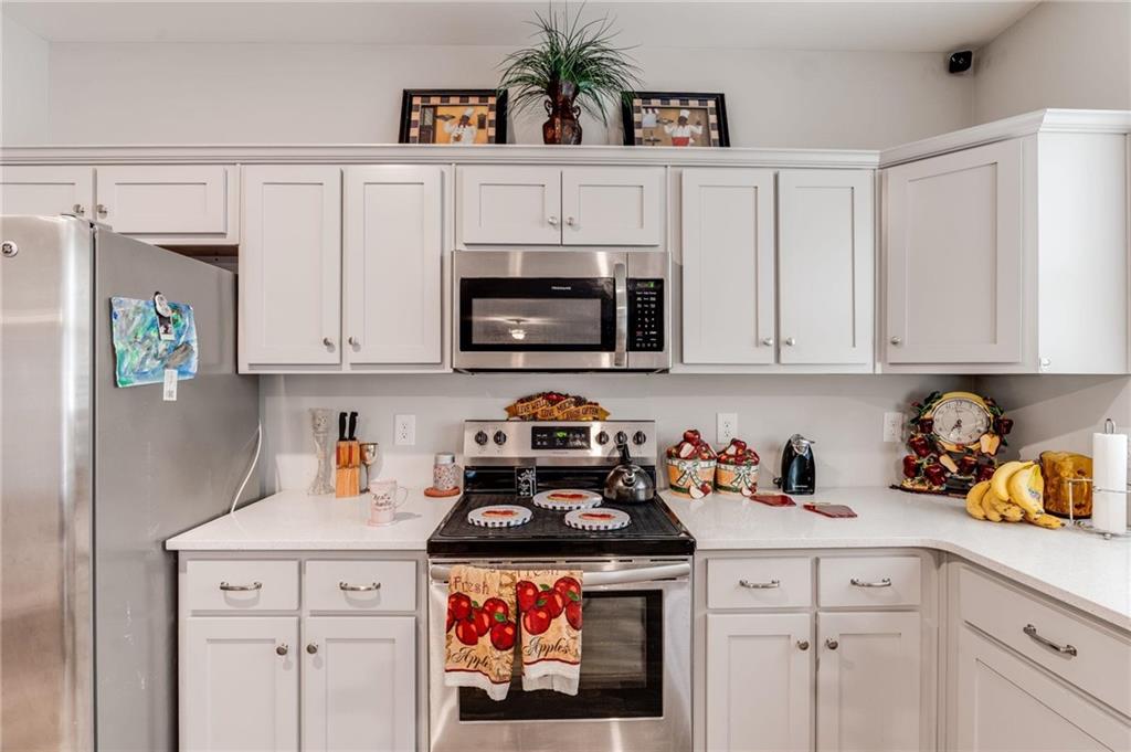 227 Waters Edge Parkway Temple, GA 30179 - Photo 9 of 26 a kitchen with white cabinets and white appliances