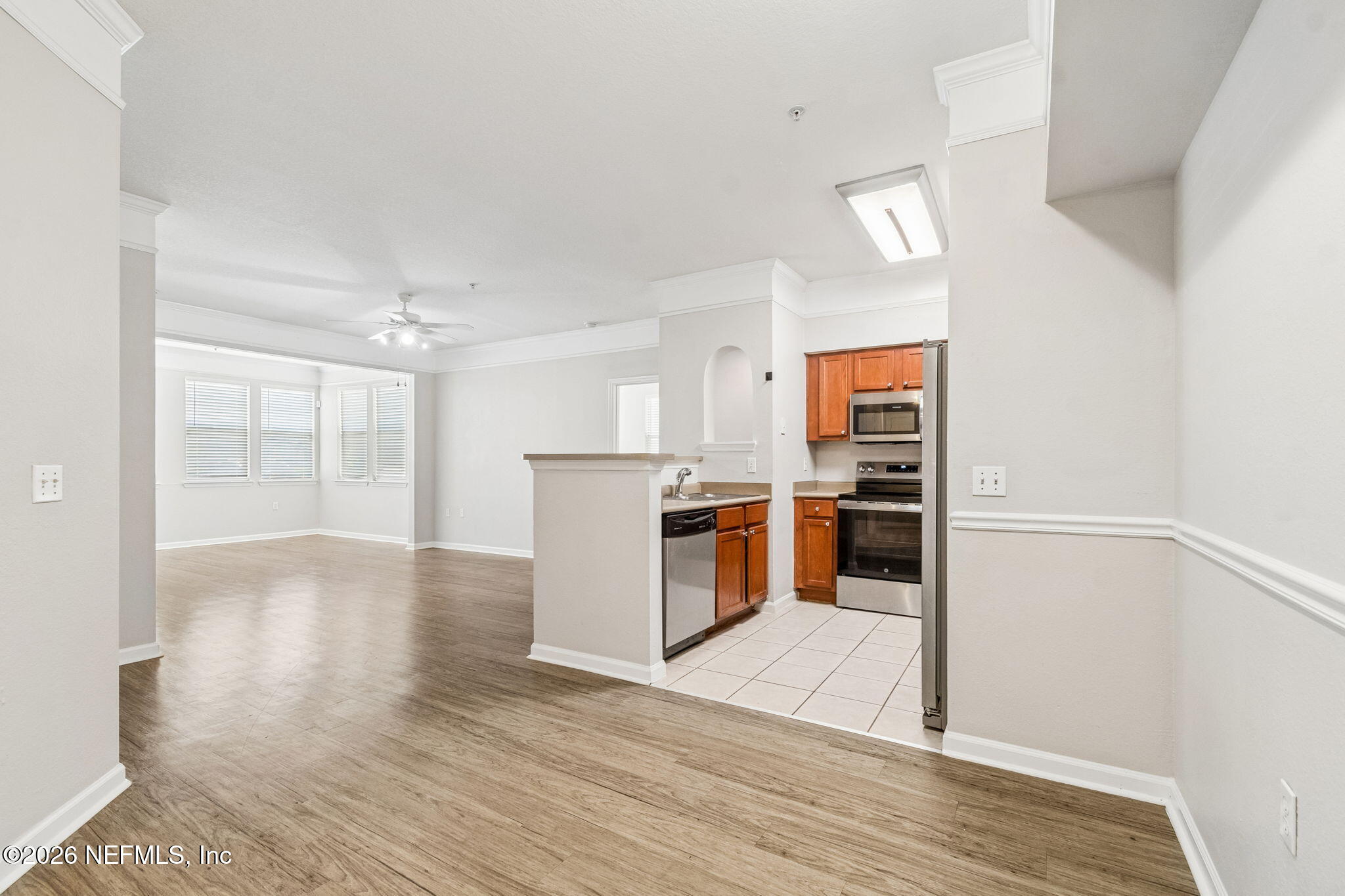 8550 Touchton Road, Unit 511 Jacksonville, FL 32216 - Photo 22 of 63 a view of open kitchen with wooden floor and electronic appliances