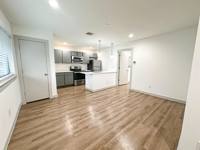 a view of a kitchen with a sink and a refrigerator