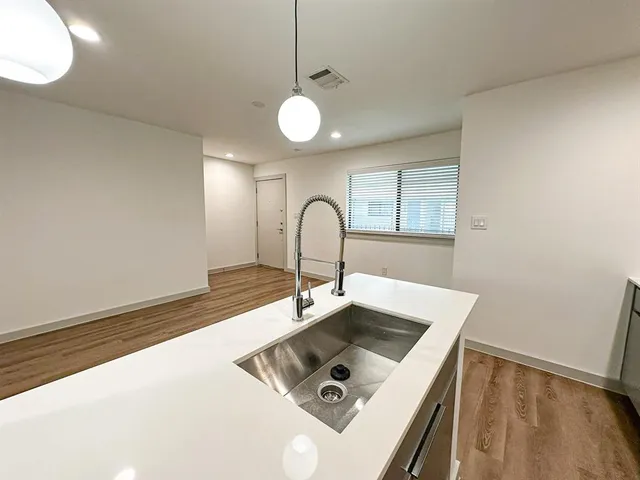 a kitchen with a sink cabinets and a window