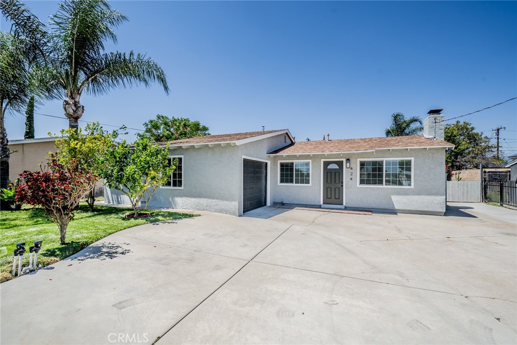 424 East Rialto Avenue Rialto, CA 92376 - Photo 1 of 1 a front view of a house with a garden and a garage