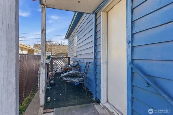 a view of a balcony and chairs and floor to ceiling window