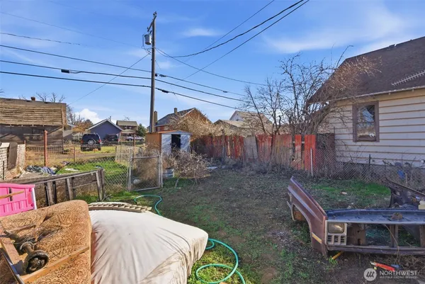 a patio with table and chairs and potted plants
