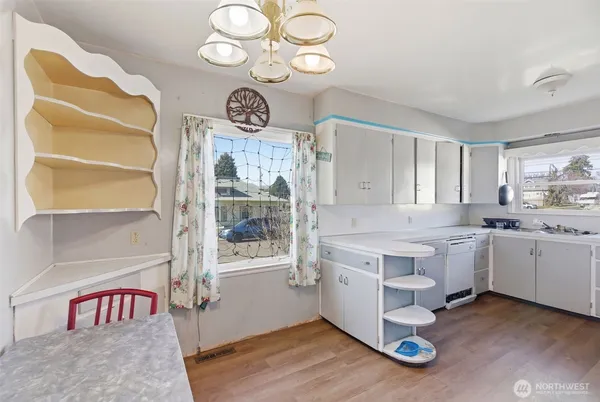 a kitchen with a stove cabinets and wooden floor