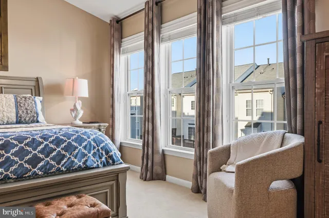 a bedroom with a bed and glass door