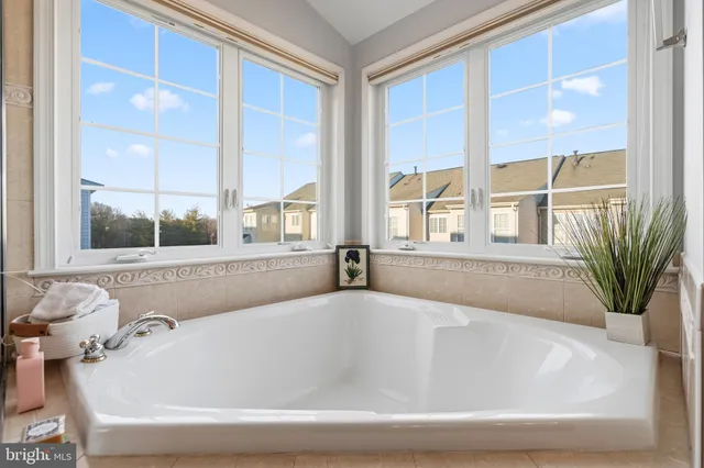 a white bath tub sitting next to a window