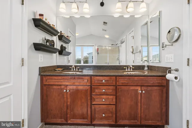 a bathroom with a sink a vanity and a large mirror