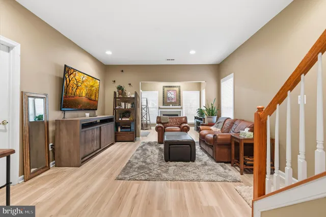 a living room with fireplace furniture and a flat screen tv