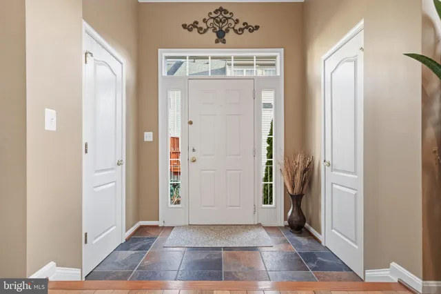 an entryway door with wooden floor