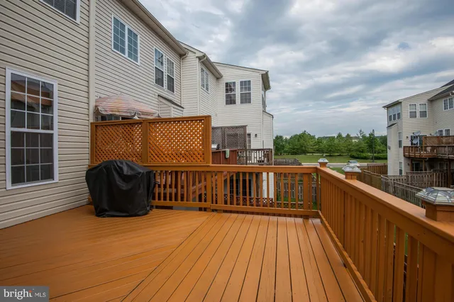 a view of a roof deck with chair and wooden floor