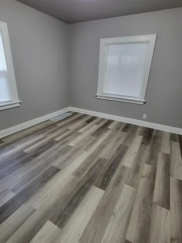 a view of a room with wooden floor and cabinet