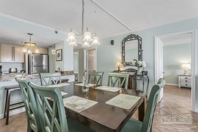 a spacious bedroom with a large bed and a chandelier