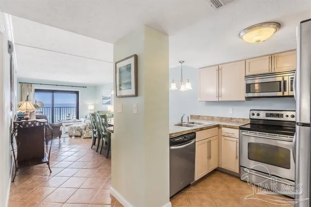 a kitchen with a refrigerator and a stove top oven