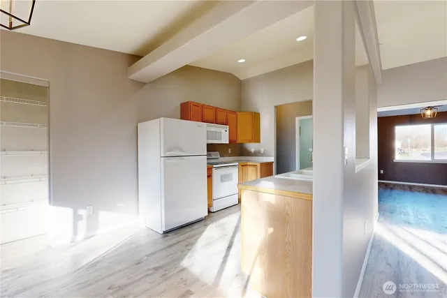 a kitchen with refrigerator and cabinets