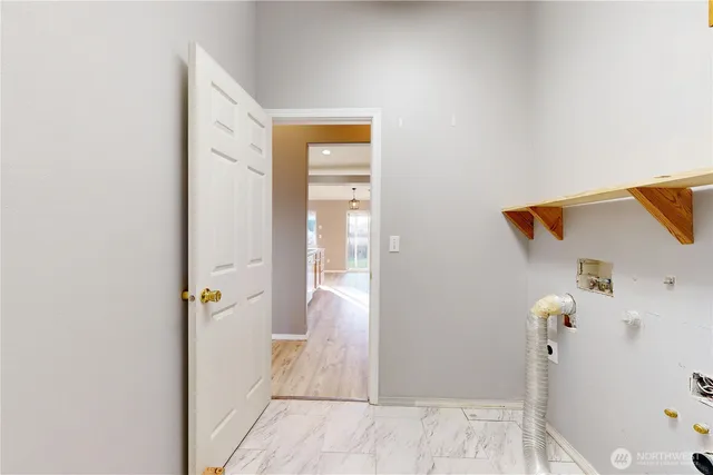 a view of a hallway with wooden floor and a living room