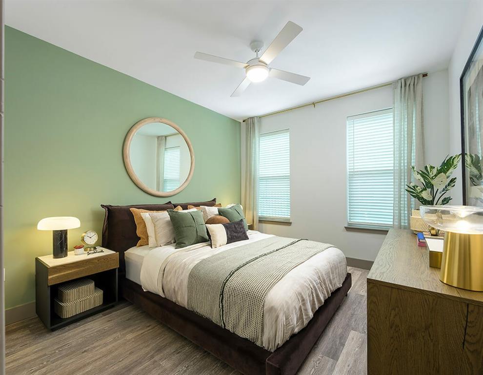 7260 Roswell Road, Unit B2 Sandy Springs, GA 30328 - Photo 11 of 23 a bedroom with a bed a dresser and potted plant