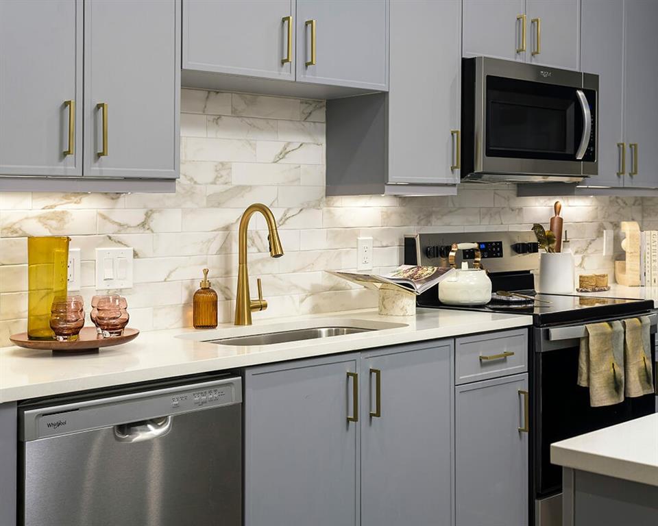 7260 Roswell Road, Unit B2 Sandy Springs, GA 30328 - Photo 14 of 23 a kitchen with stainless steel appliances granite countertop a sink a stove microwave and cabinets