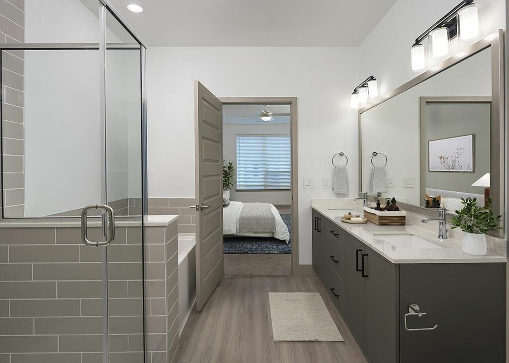 7260 Roswell Road, Unit B2 Sandy Springs, GA 30328 - Photo 9 of 23 a spacious bathroom with a double vanity sink and mirror