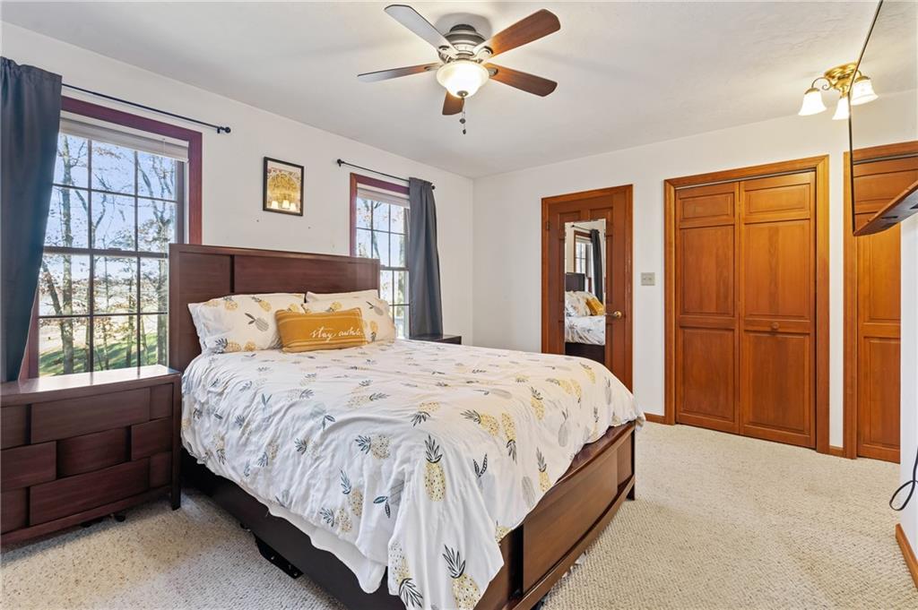 158 Becker Road Butler, PA 16002 - Photo 14 of 32 a bedroom with a large bed and a chandelier