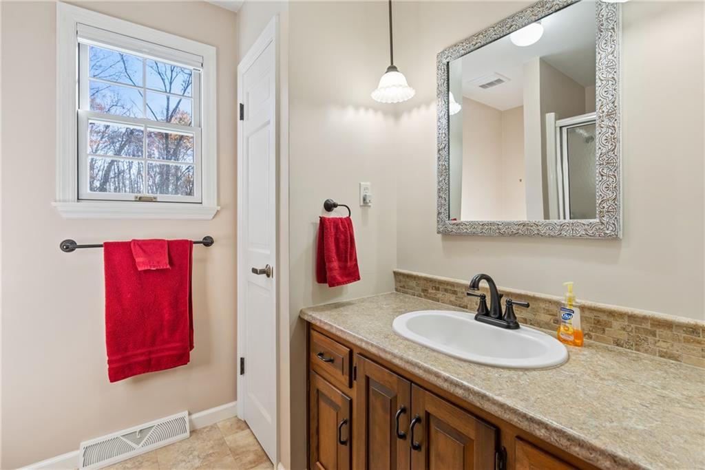 158 Becker Road Butler, PA 16002 - Photo 17 of 32 a bathroom with a sink vanity and a mirror