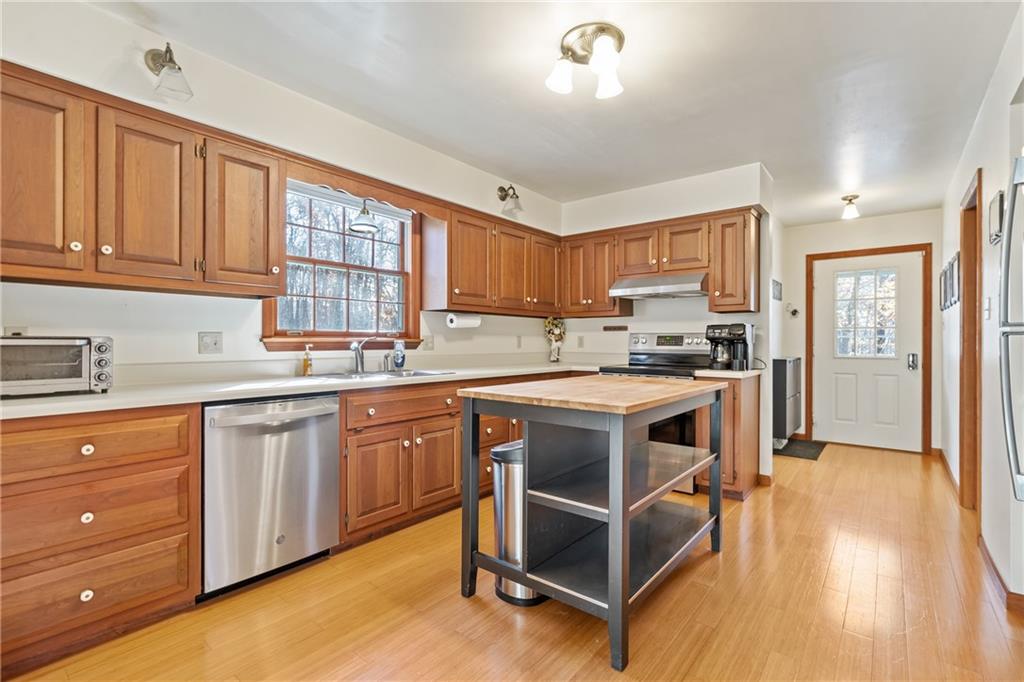 158 Becker Road Butler, PA 16002 - Photo 2 of 32 a kitchen with granite countertop wooden cabinets and white appliances