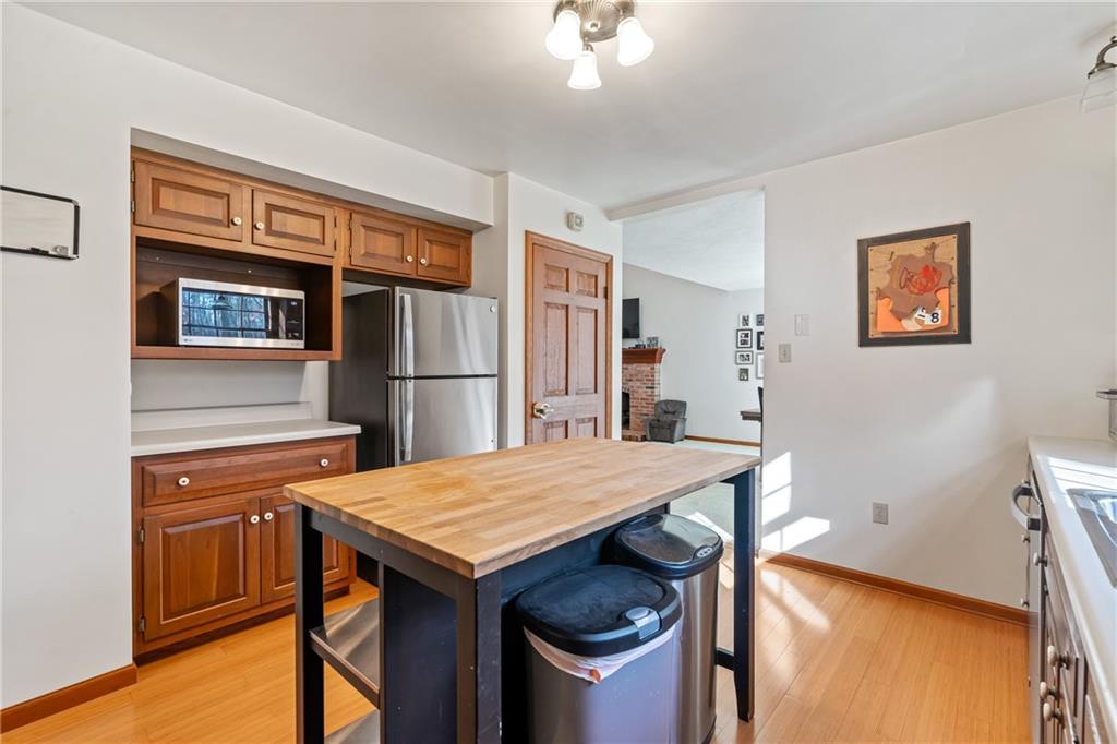 158 Becker Road Butler, PA 16002 - Photo 7 of 32 a kitchen with a wooden floor and a refrigerator