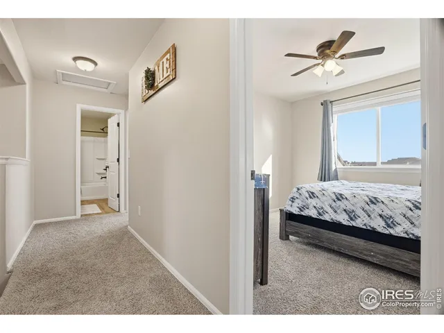 a bedroom with a bed and a ceiling fan