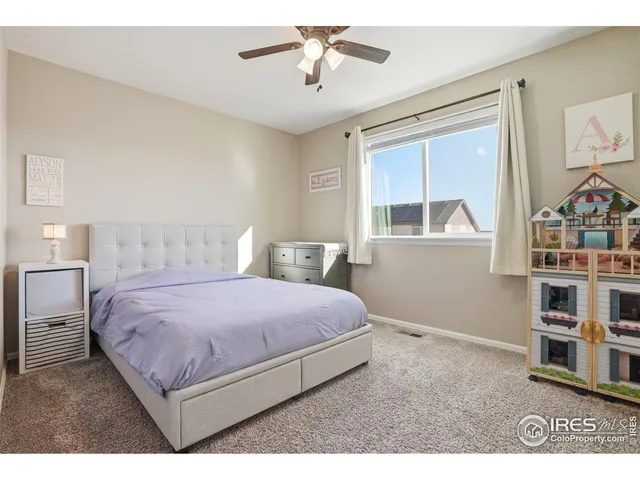 a bedroom with a large bed and a window