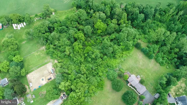 an aerial view of a house with yard