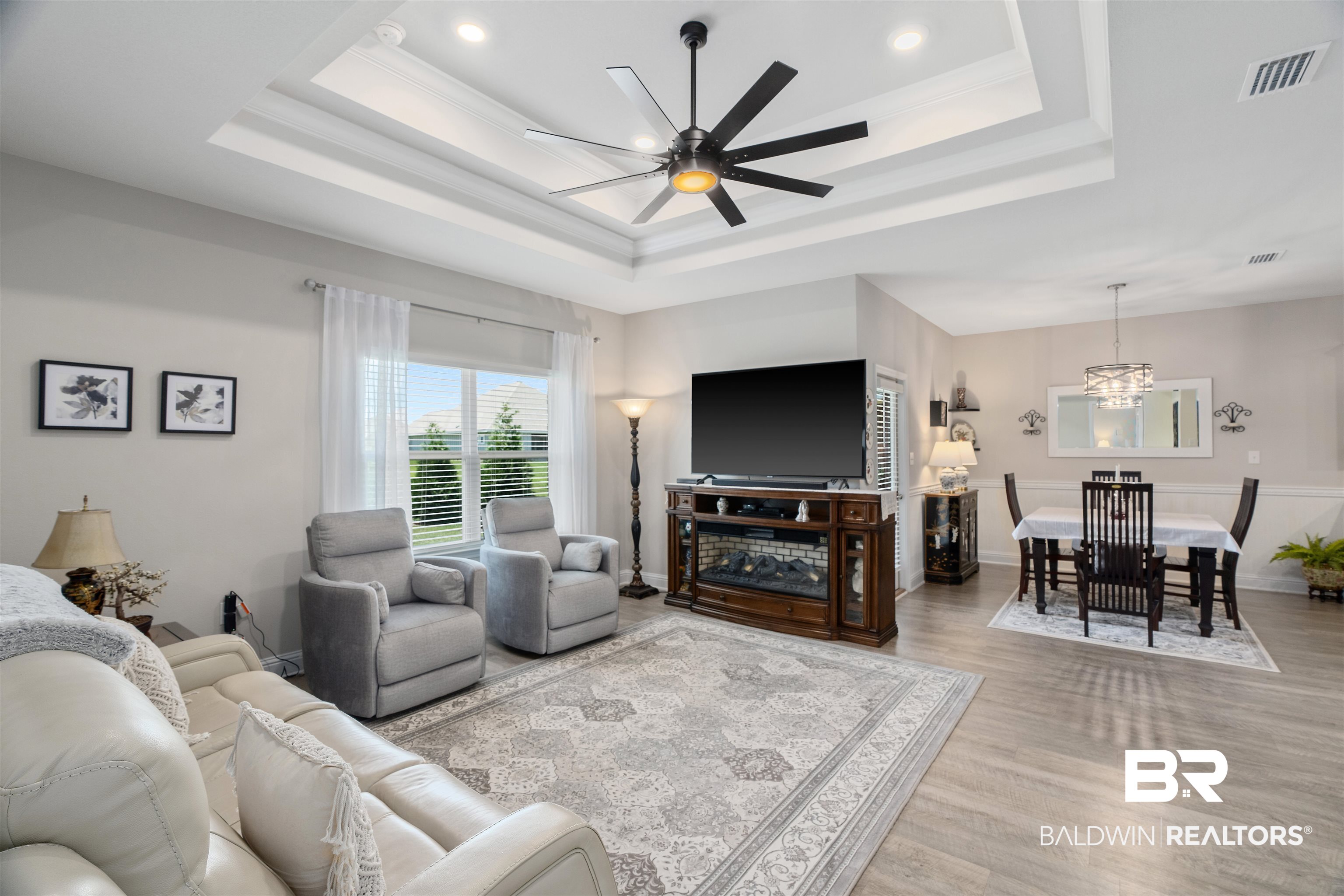 24593 Slater Mill Road Daphne, AL 36526 - Photo 10 of 32 Living area with a tray ceiling, a chandelier, wood finished floors, a ceiling fan, and recessed lighting