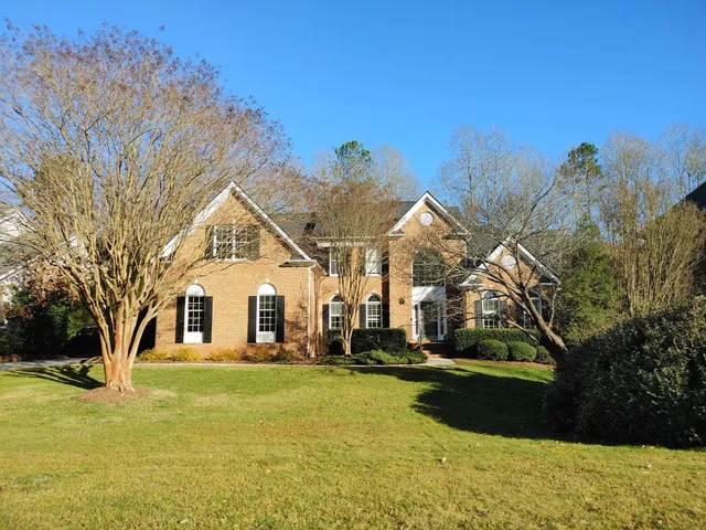 a view of a house with pool and trees