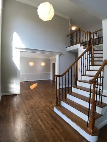 a view of entryway and hall with wooden floor