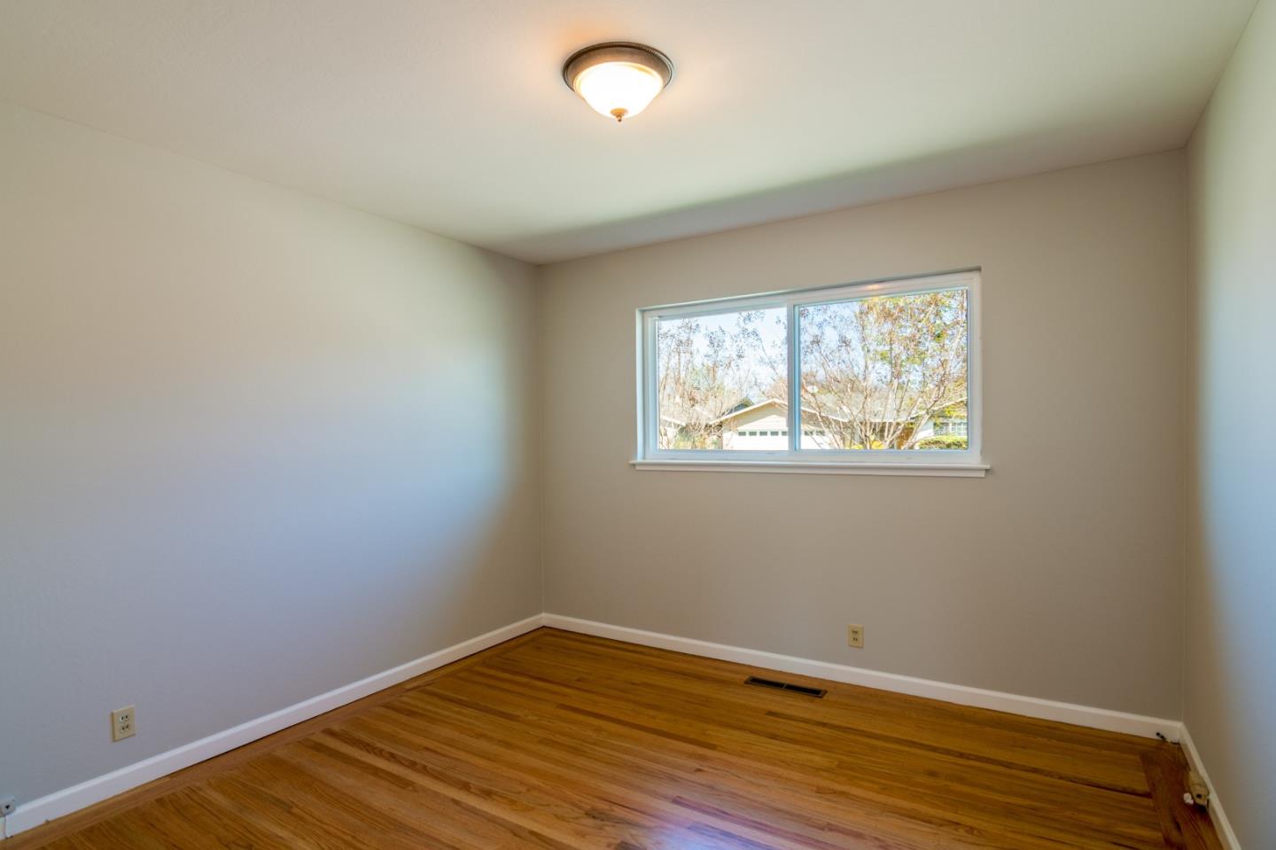 4638 Borina Drive San Jose, CA 95129 - Photo 17 of 24 an empty room with wooden floor and windows