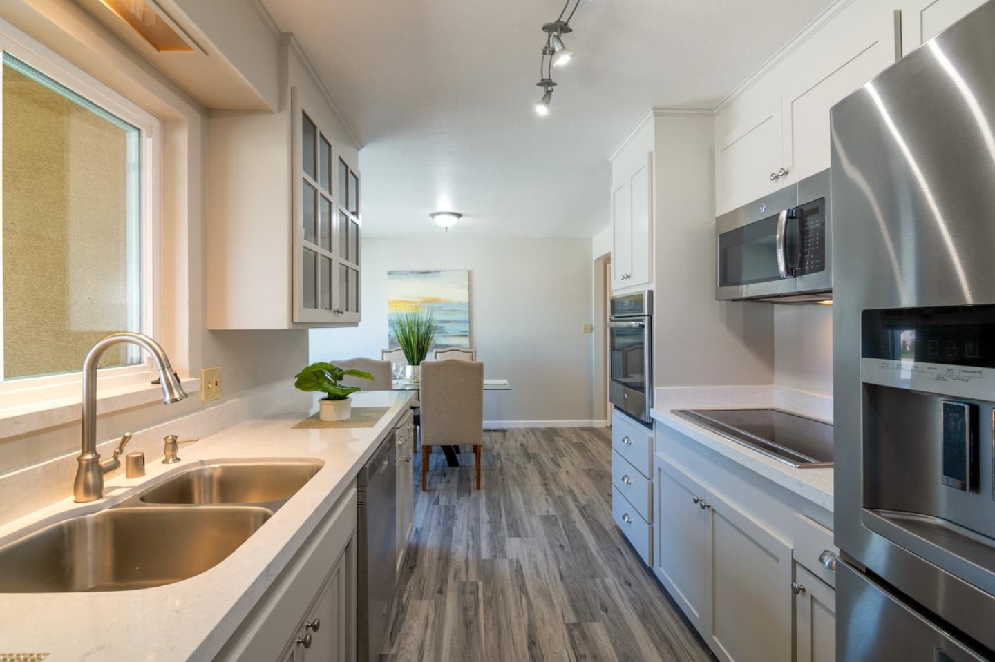 4638 Borina Drive San Jose, CA 95129 - Photo 9 of 24 a kitchen with a sink cabinets and stainless steel appliances