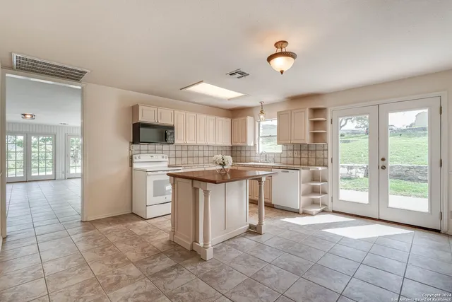 a kitchen with a sink cabinets and window