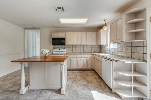 a kitchen with sink cabinets and window