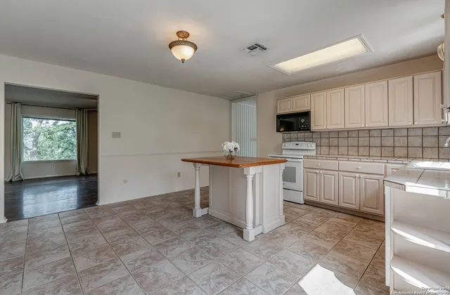 a kitchen with stainless steel appliances granite countertop a sink and a microwave